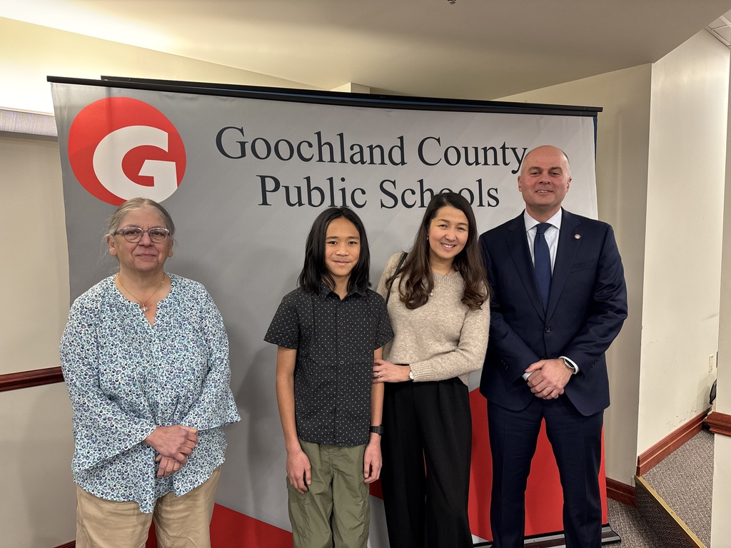 Photo of Ms. Moses, Spelling bee winner, his mother, and Dr. Armstrong