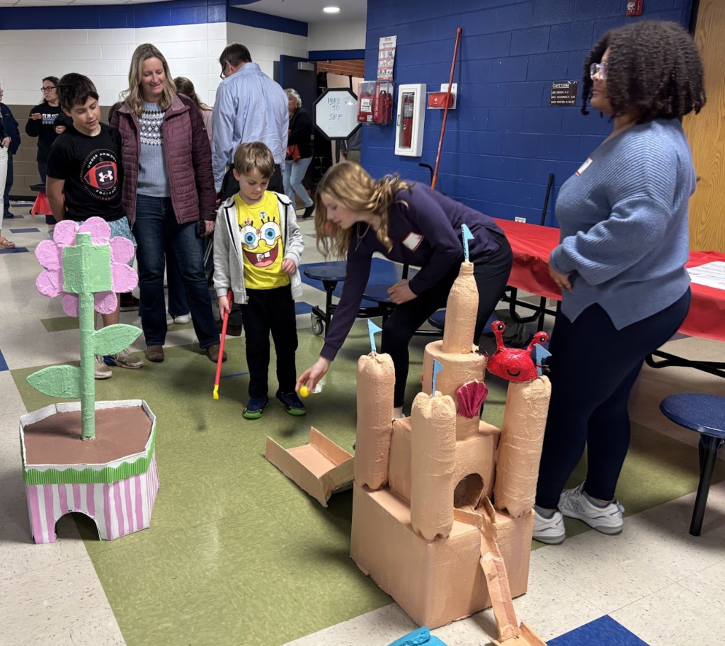 Student playing mini golf