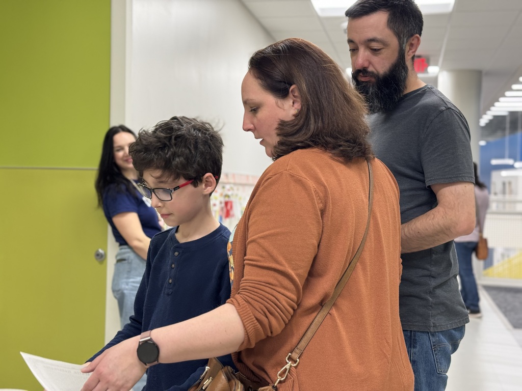 Family looking at a piece of paper