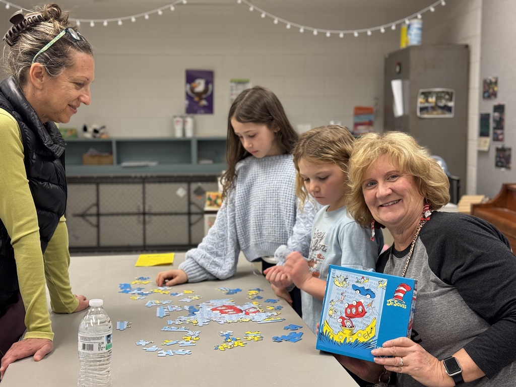 Group posing with a puzzle