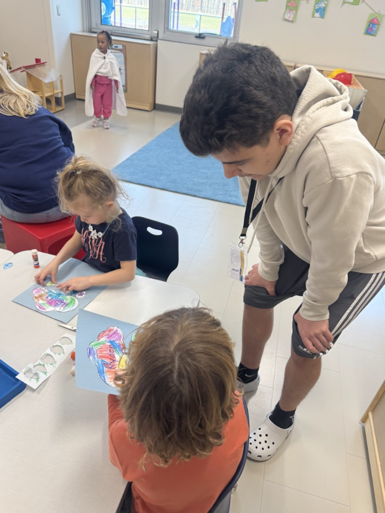 Boy helping elementary student