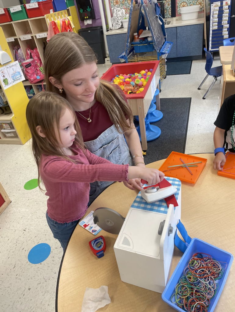 Girl playing with elementary student
