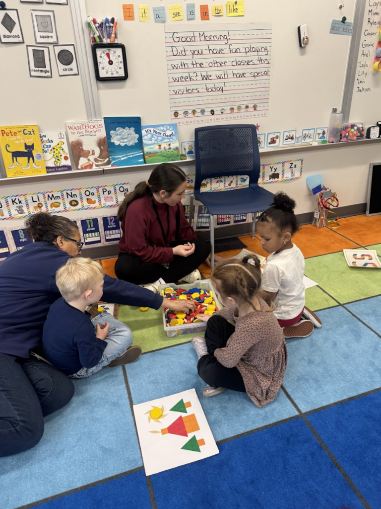 Girl helping elementary students