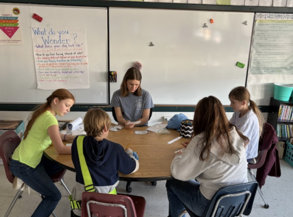 Girl teaching group of elementary students
