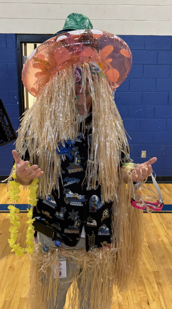 Mr. Gordon with a hula skirt and an inner tube on his head