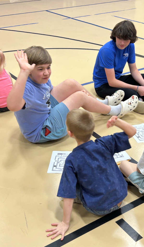 Middle school boy and elementary school boy high fiving