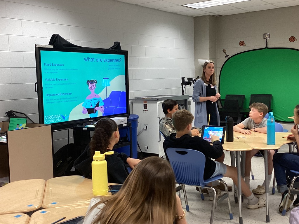 Woman presenting on expenses to middle school students