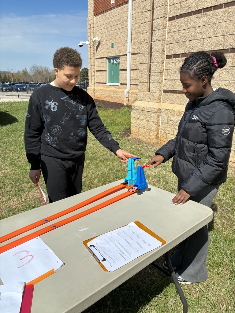 Two students prepare to launch Hot Wheels
