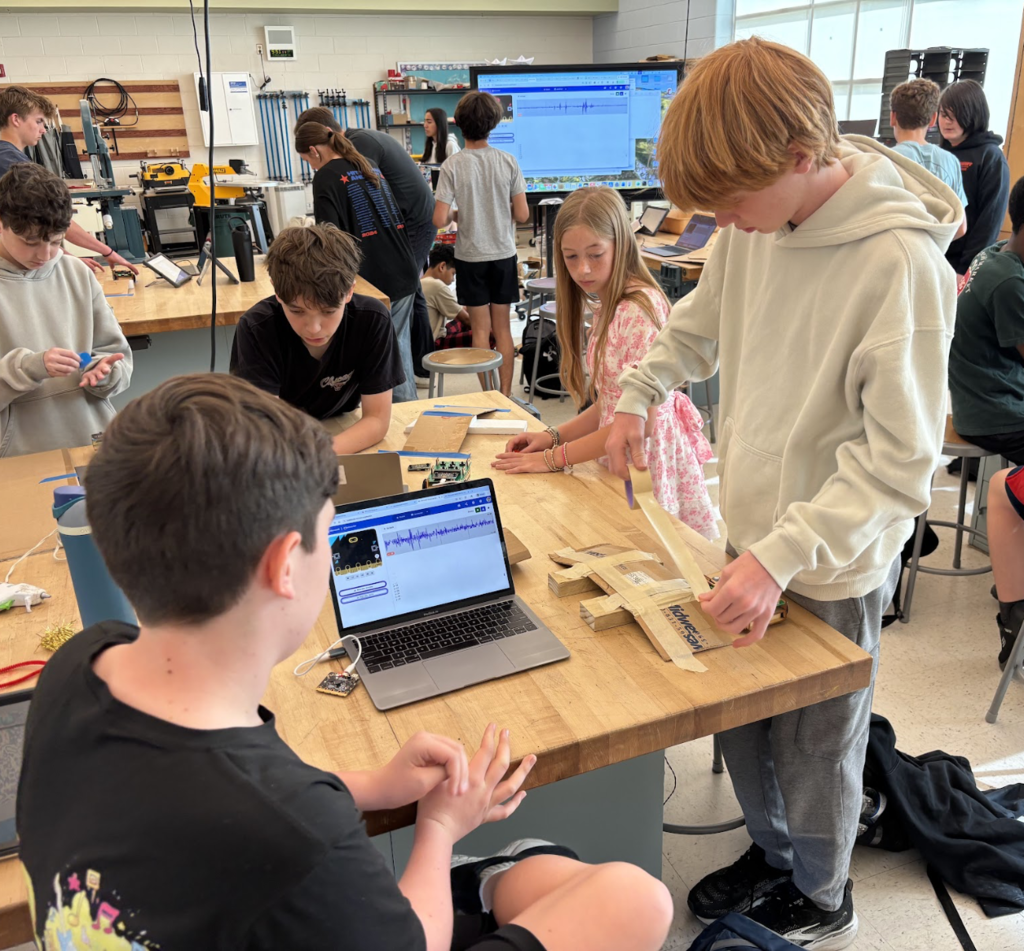 Students building ramp for Roversa robot and seeing data from their ramp