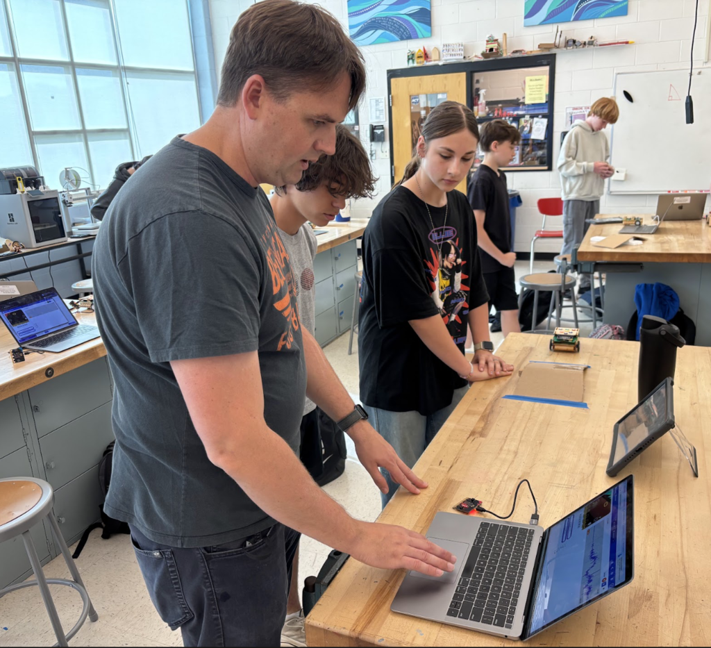 Teacher working with students on coding micro:bit
