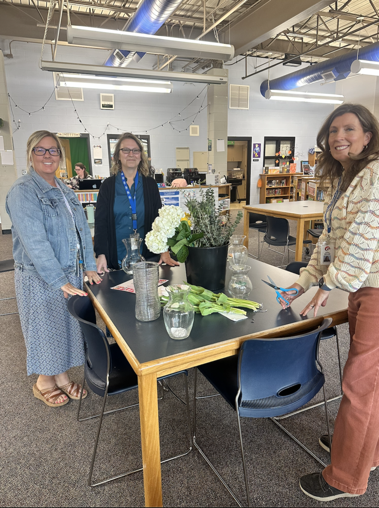 Ms. Davis, Ms. Matthews, Ms. Weller prepare their bouquets