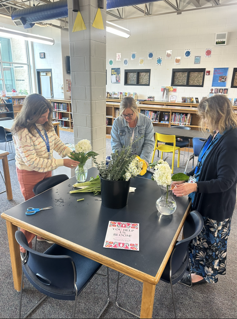 Ms. Davis, Ms. Matthews, Ms. Weller prepare their bouquets