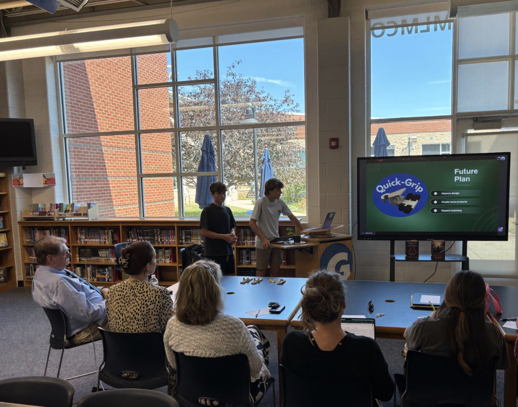 Students presenting in front of a panel of judges