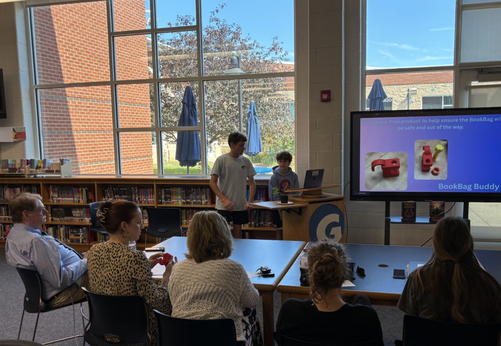 Students presenting in front of a panel of judges