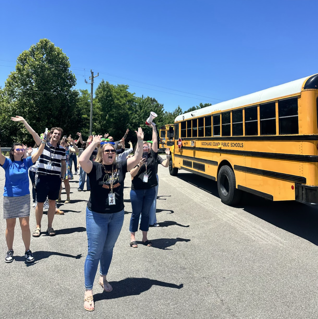 Teachers waving to buses