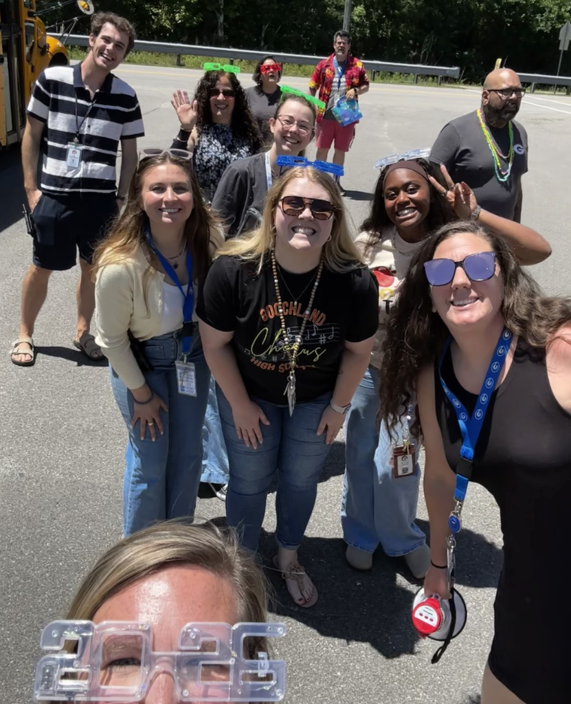 Teachers smiling and waving to camera