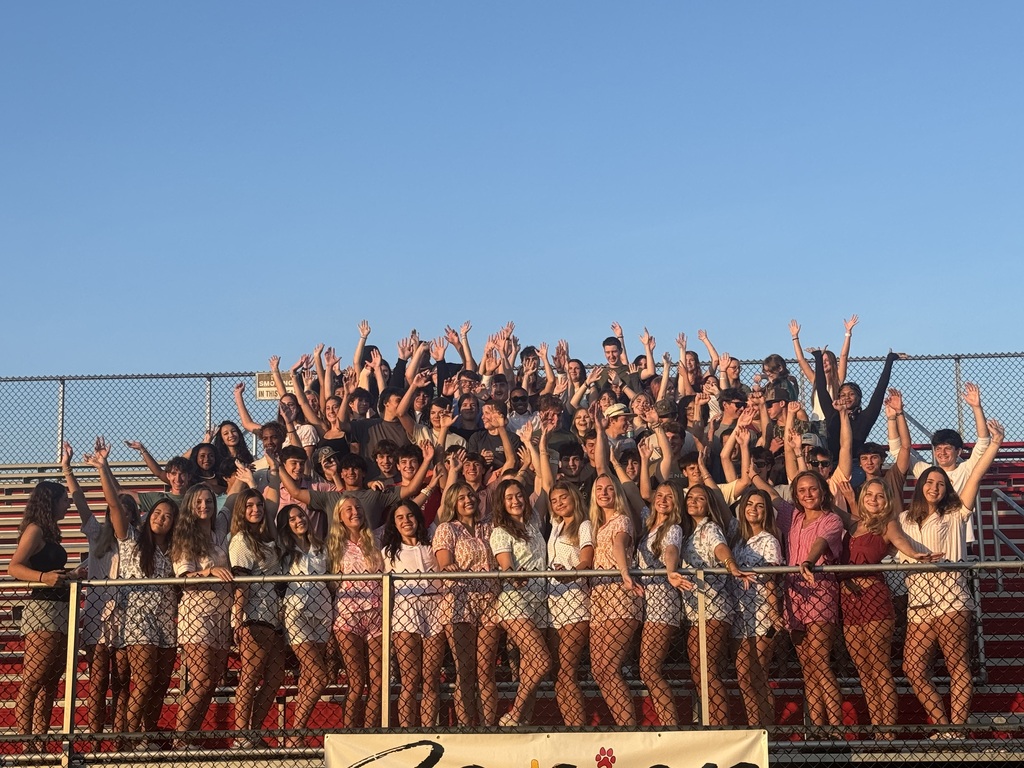 seniors on bleachers waving
