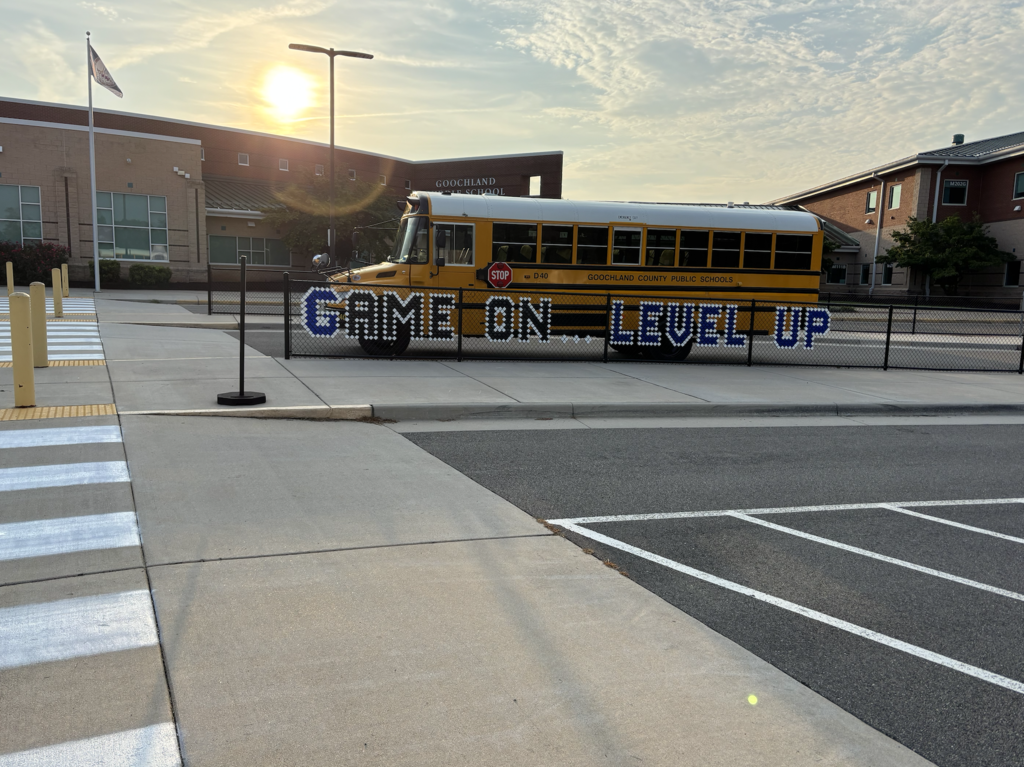 GMS building with a school bus in front and the Game On Level Up sign
