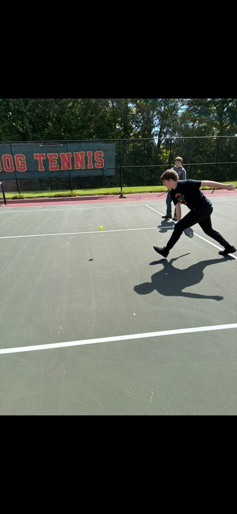 Student hitting the pickleball