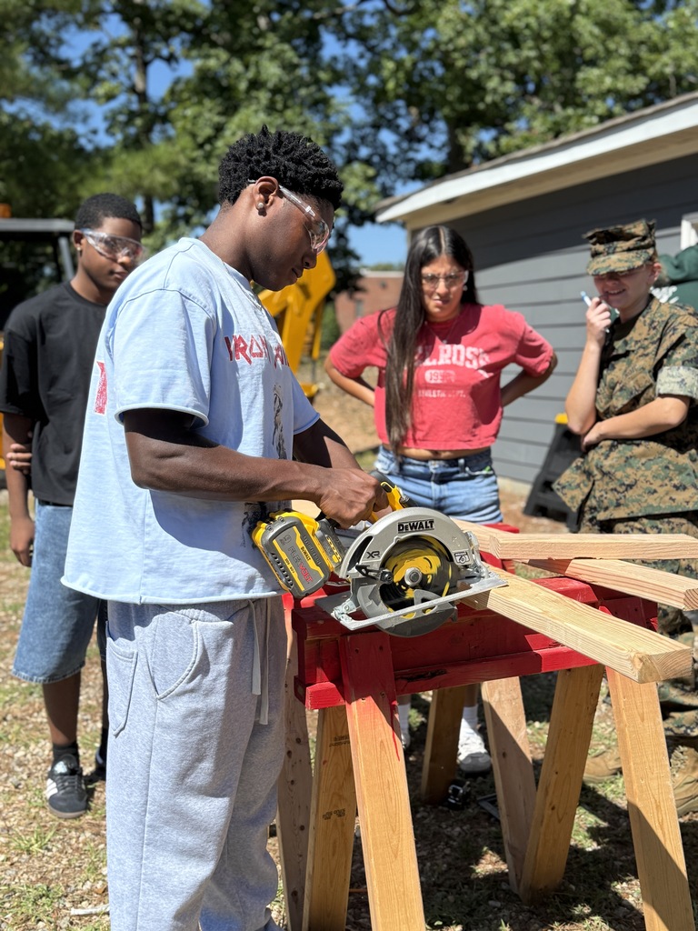 students watching another student use the circular saw
