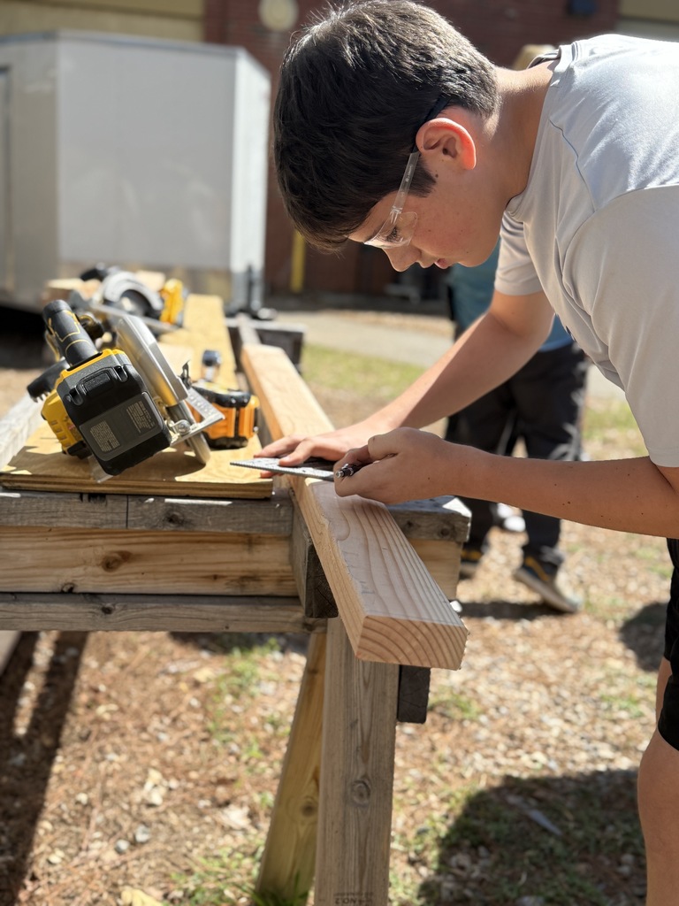 student measuring to cut