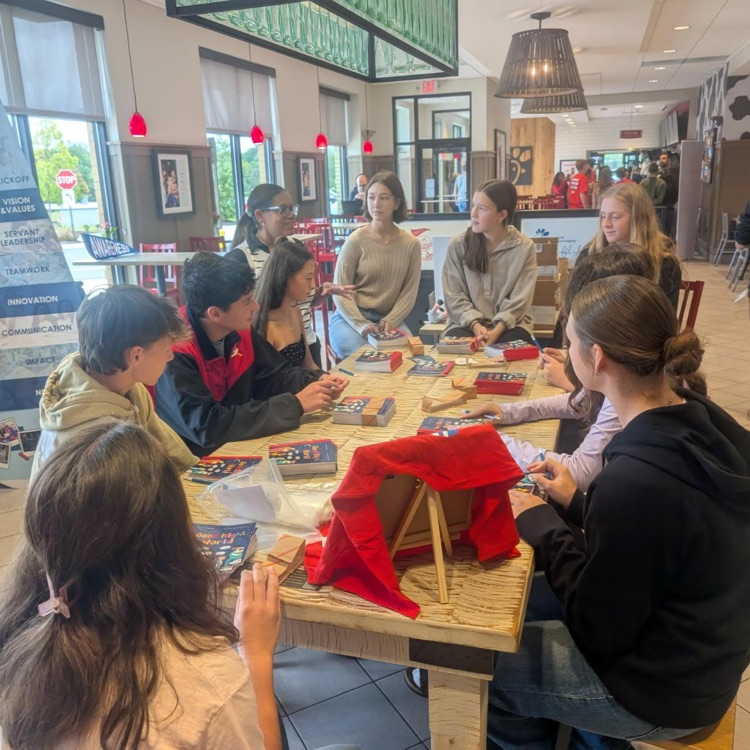 students sitting together at a table 