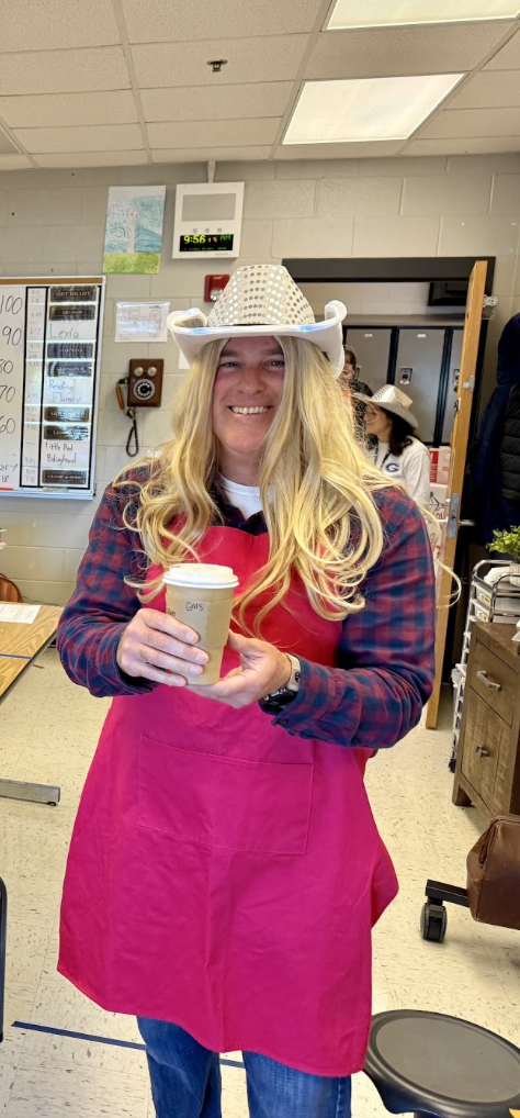 Mr. Gordon surprising a teacher with a coffee dressed as Dolly Parton