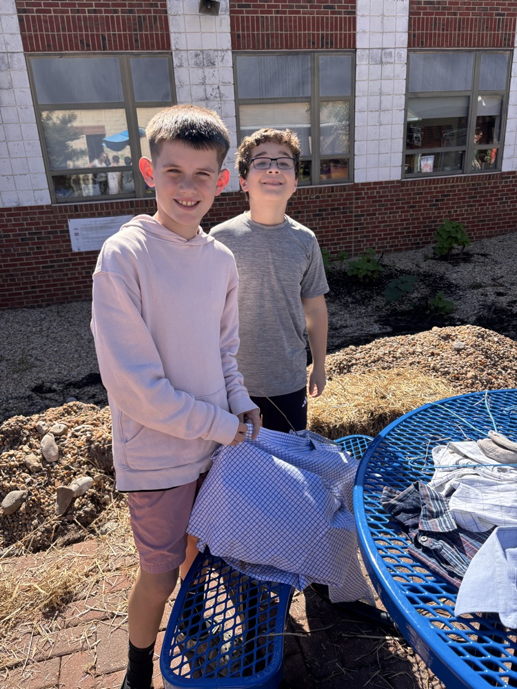 two boys making their scarecrow