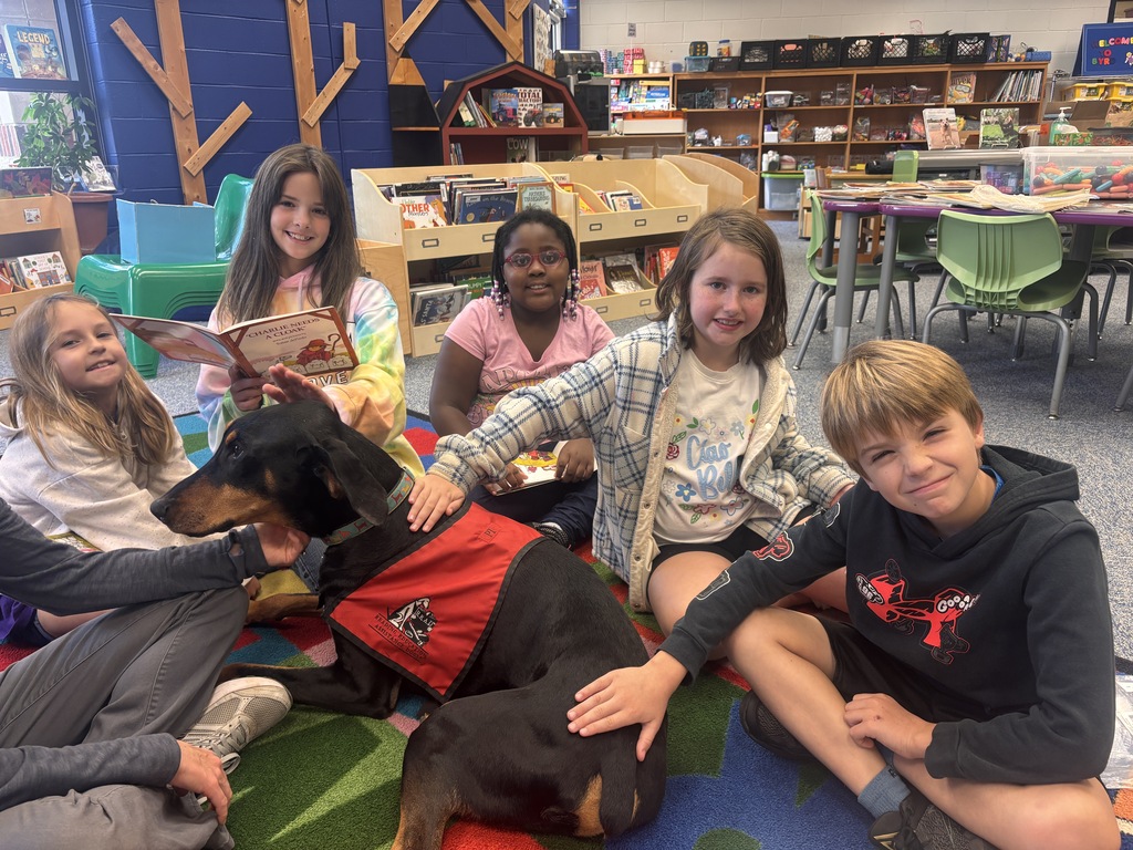 Students petting the Reading Therapy Dog, Pi