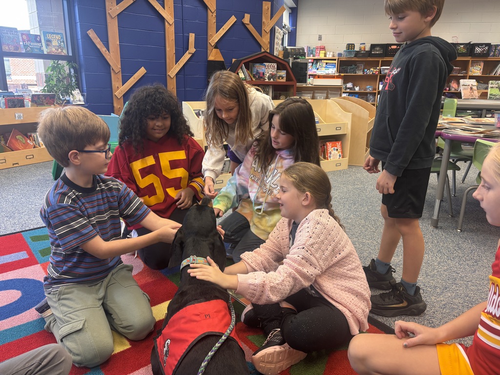 Students petting the Reading Therapy Dog, Pi