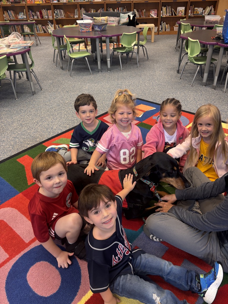 Students petting the Reading Therapy Dog, Pi