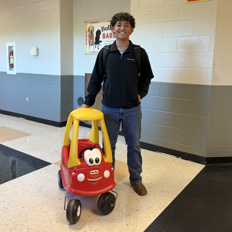 student with play car
