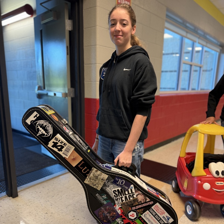 student with guitar case 