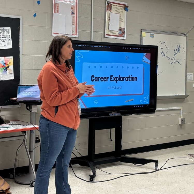 Mrs. Ferrell standing next to a board that says “career exploration” 