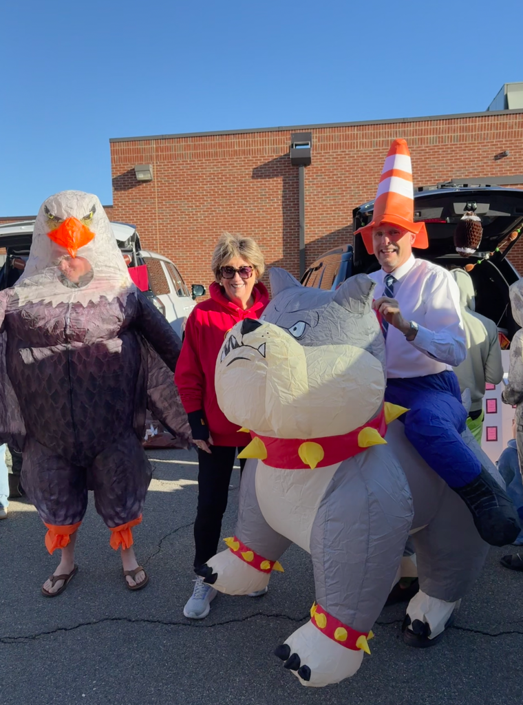The mascots with a volunteer