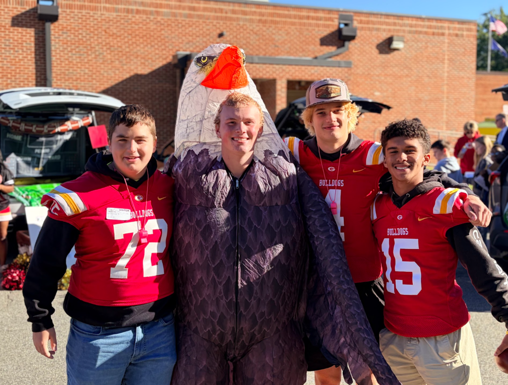 High school football players smiling for a picture together