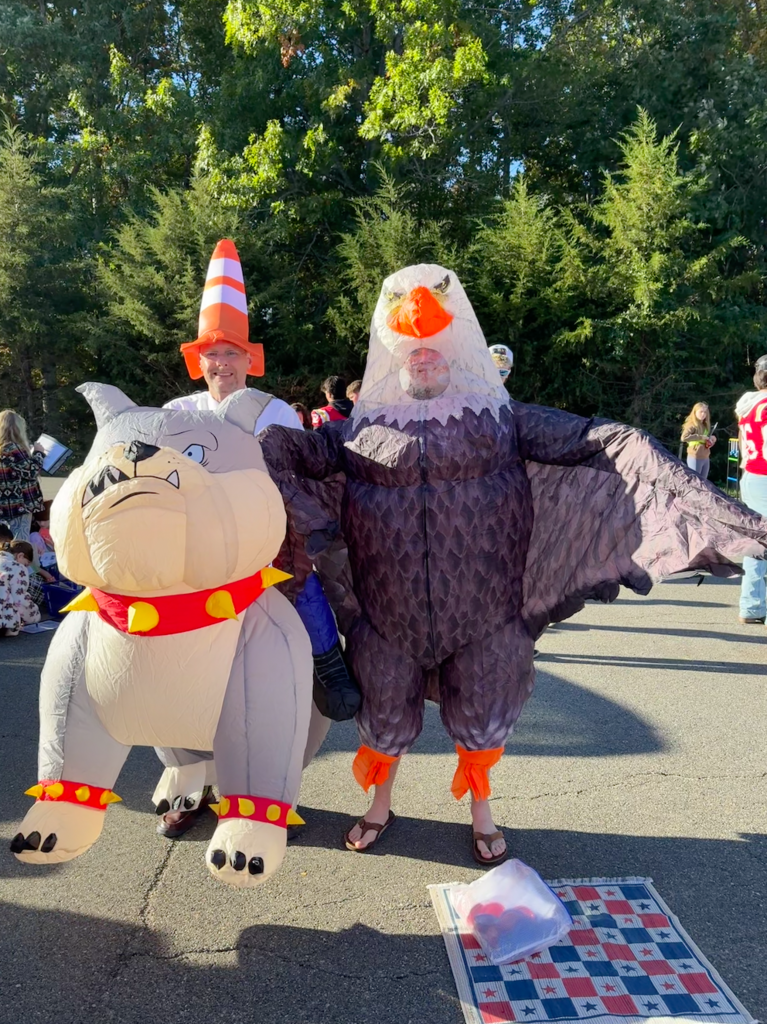 A teacher wearing a bulldog costume and a student wearing an eagle costume.