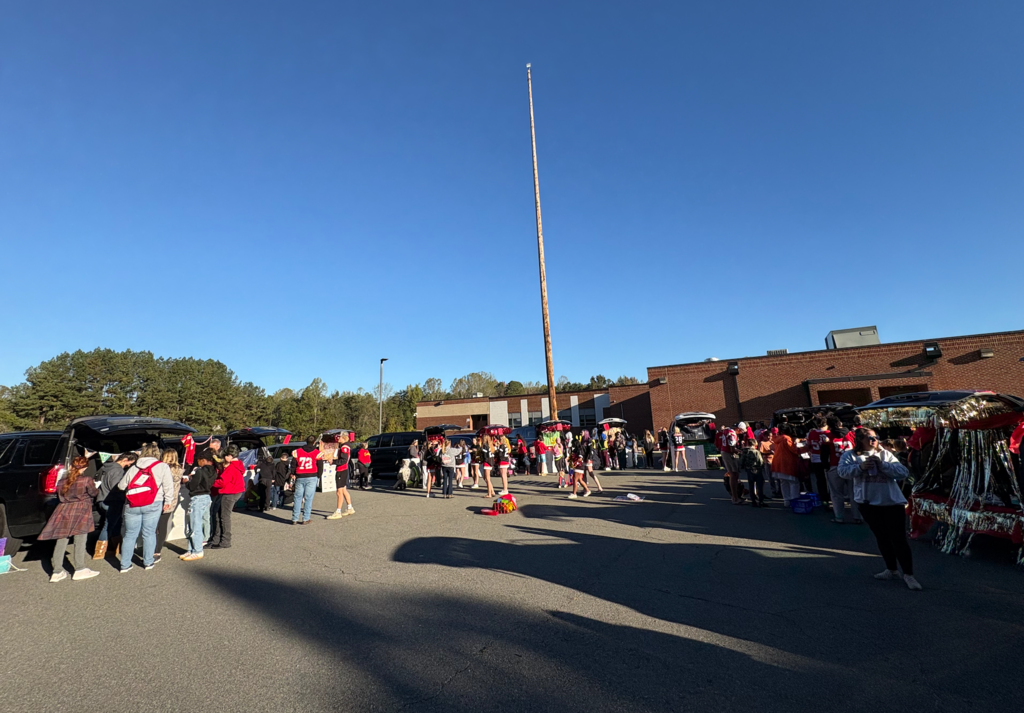 A picture depicting the car loop with groups of students completing activities at car tailgates