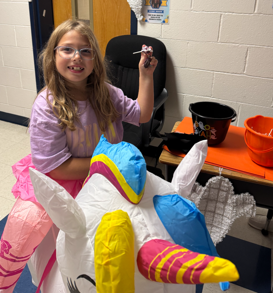 A student wearing an inflatable unicorn costume