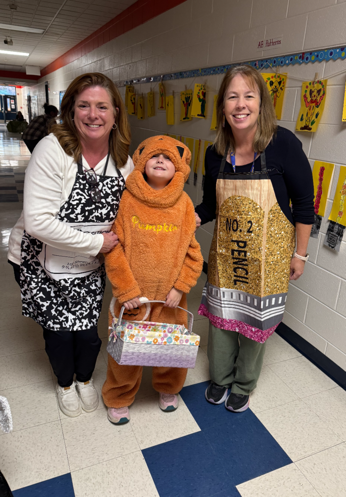 Two teachers with a student wearing Halloween costumes.