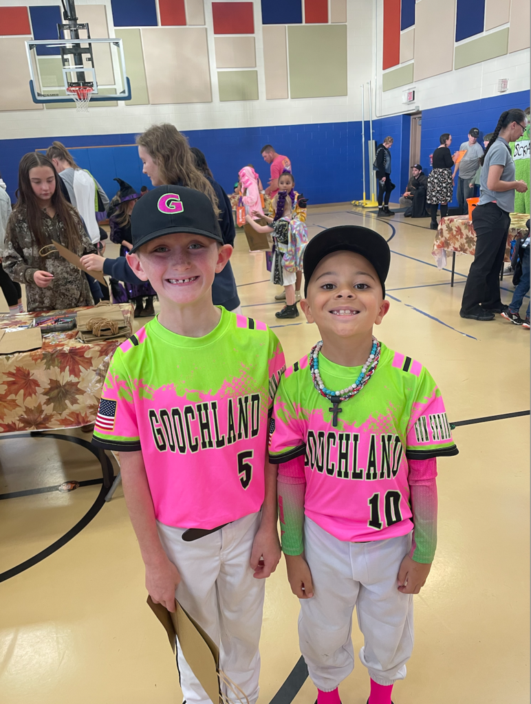 Two students wearing matching baseball uniforms as costumes.
