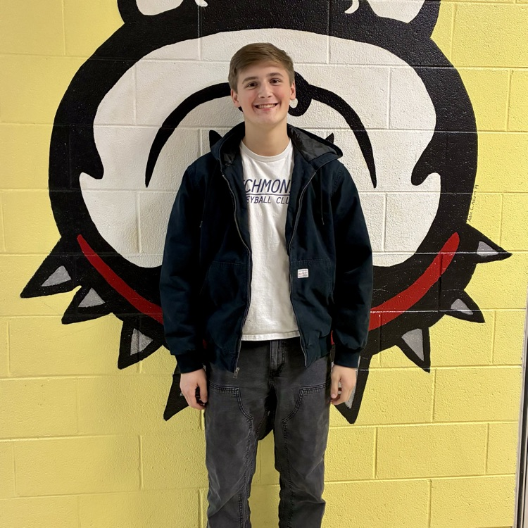 student standing in front of a bulldog picture 