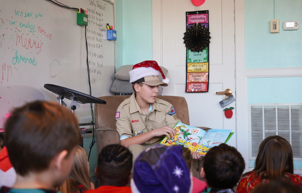 Boy scout reading to students