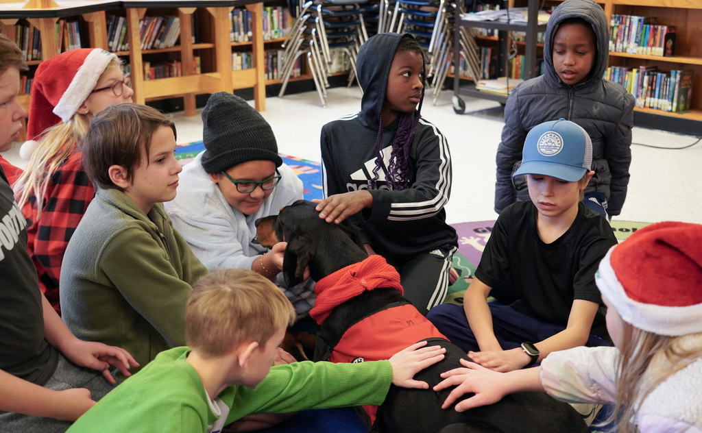 Students petting service dog