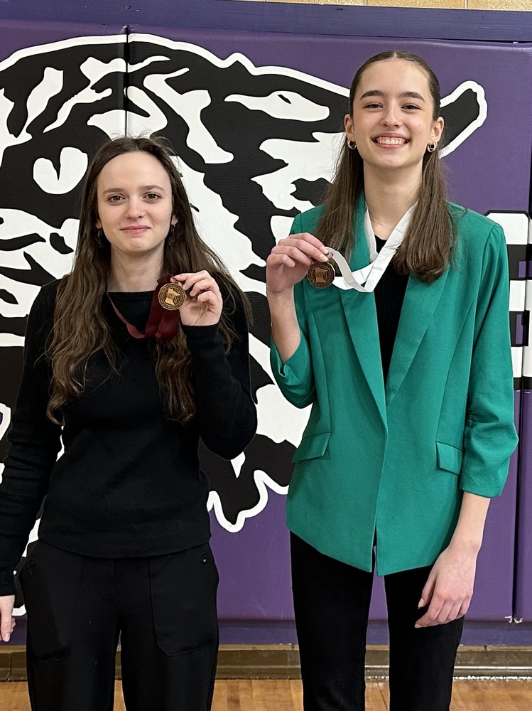 2 Students standing with medals