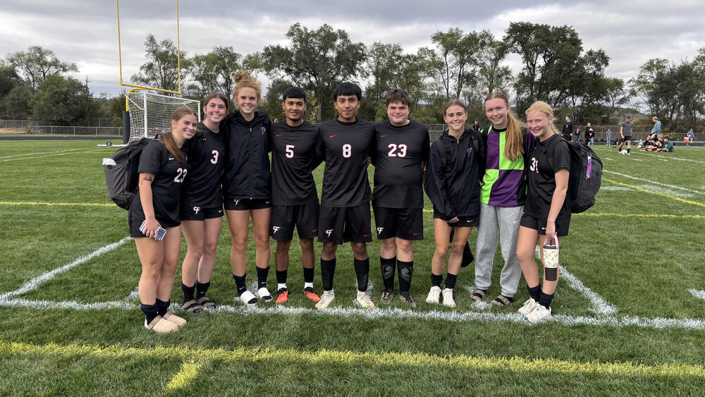 Students pose for a soccer picture
