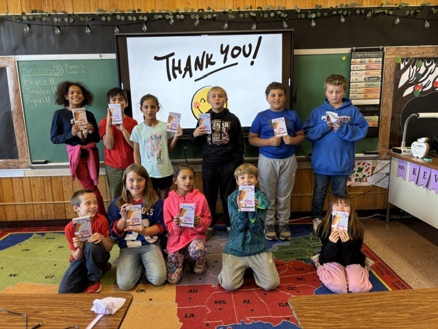 11 - 3rd/4th grade students receiving their books from "Sponsor a Reader" program 