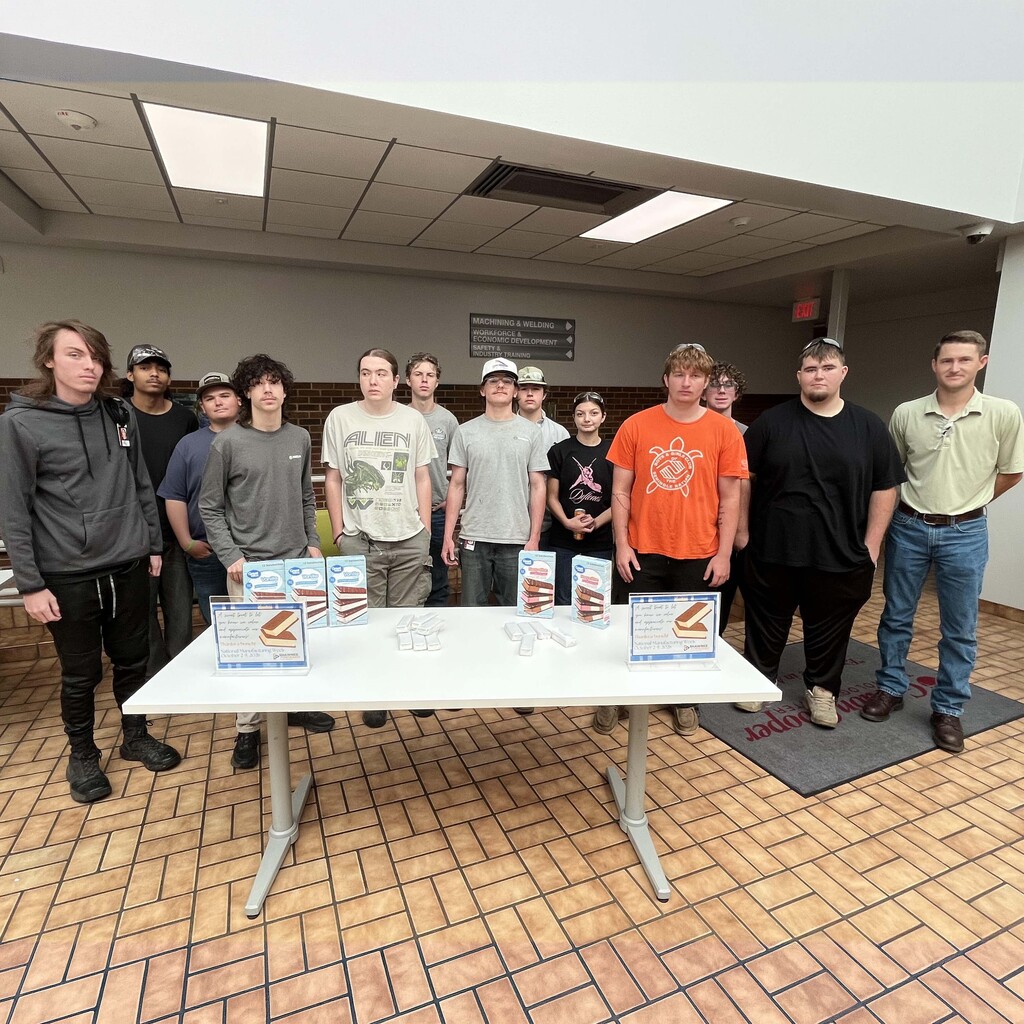 Machining students pose for a picture with ice cream sandwiches 