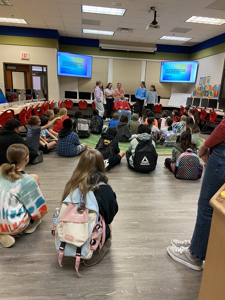 Group of children listening to adult speak