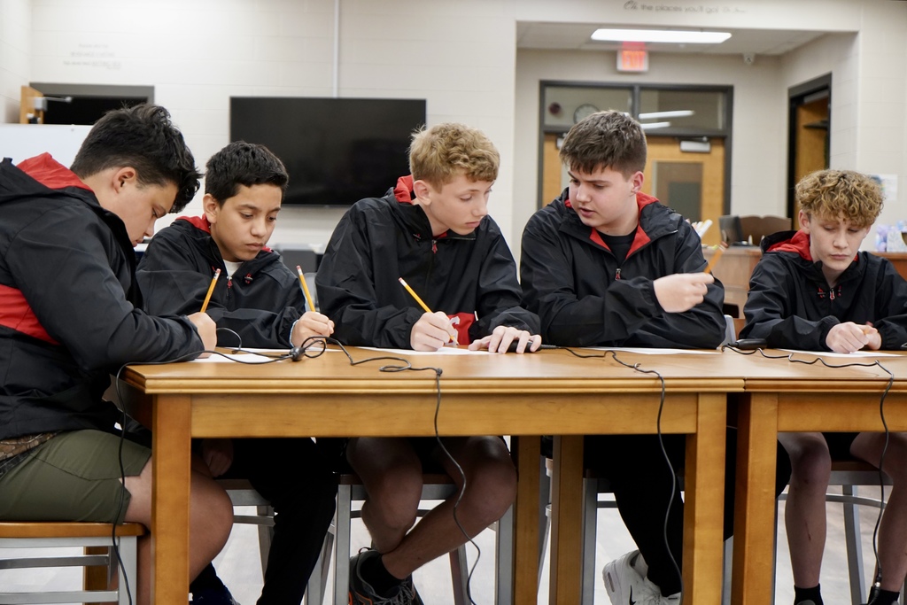 A group of 5 boys studying.